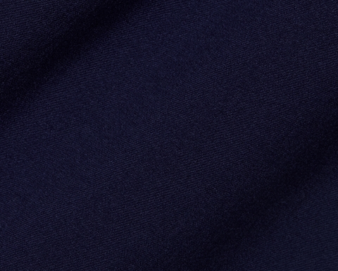 Close-up of The McDaniel 5 Pocket Pant: Navy, showcasing its fine woven texture, highlighting wrinkle-resistant, quick-dry performance fabric with eco-friendly recycled polyester and elastane blend.