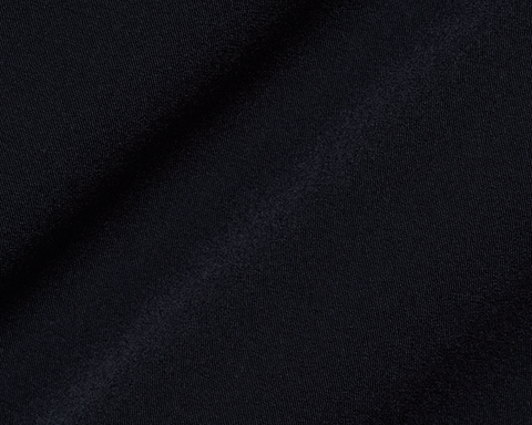 Close-up of The Saunders Short: Black, showcasing its fine knit texture and subtle folds, highlighting its quick-drying, stretchable fabric designed for optimal performance.