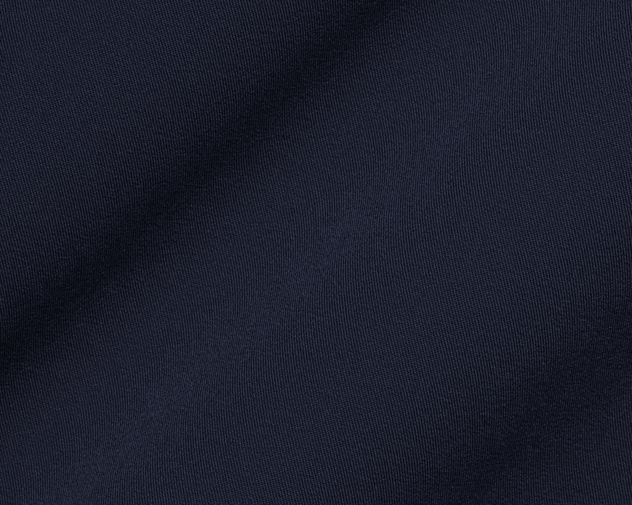 The Saunders Short: Navy, showcasing its dark blue woven fabric with a subtle drape, highlighting the fine weave and texture for optimal performance.