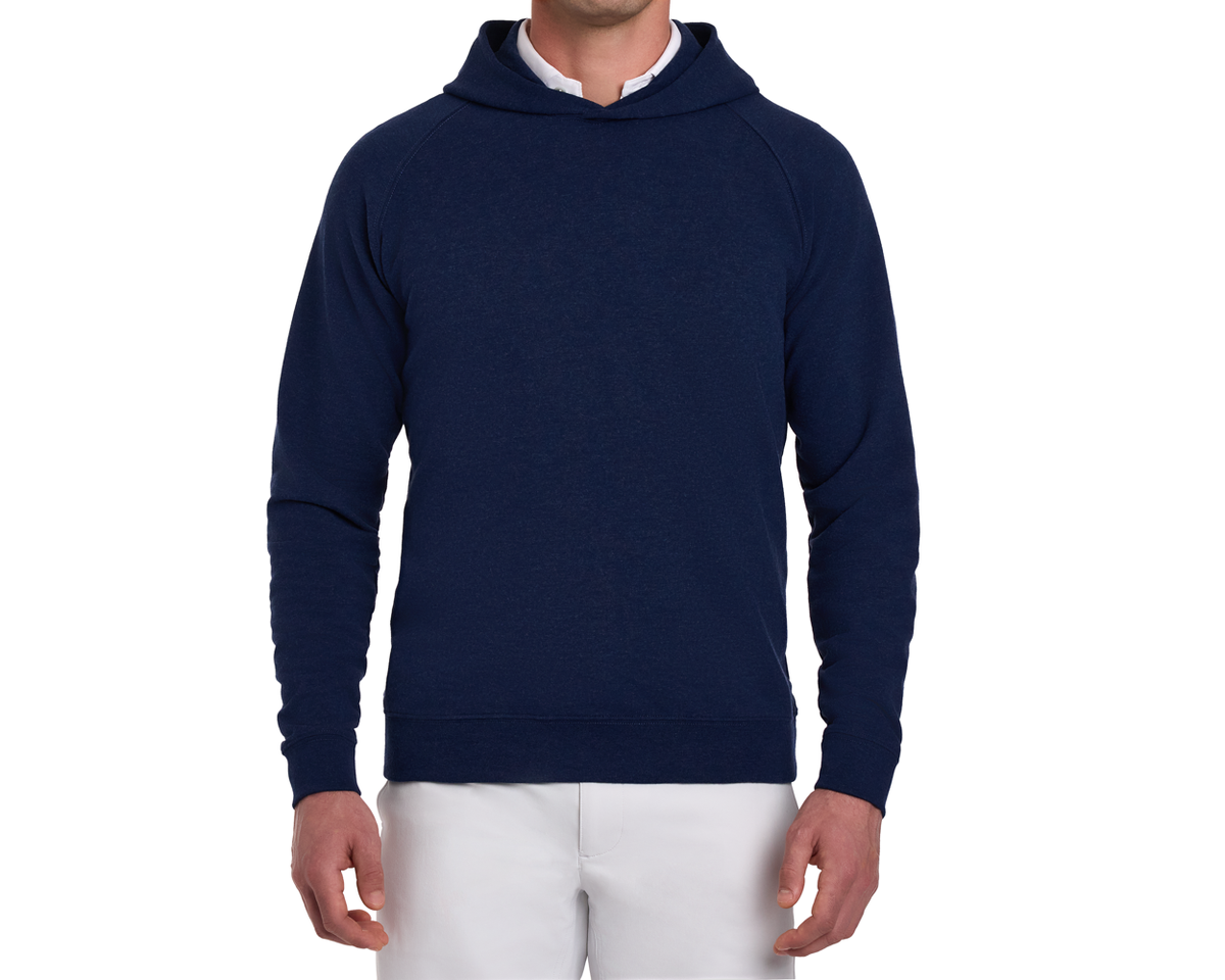 The Lawson Hoodie: Heathered Atlantic shown on a model, features a clean design with raglan sleeves, ribbed cuffs, over a white shirt and pants.