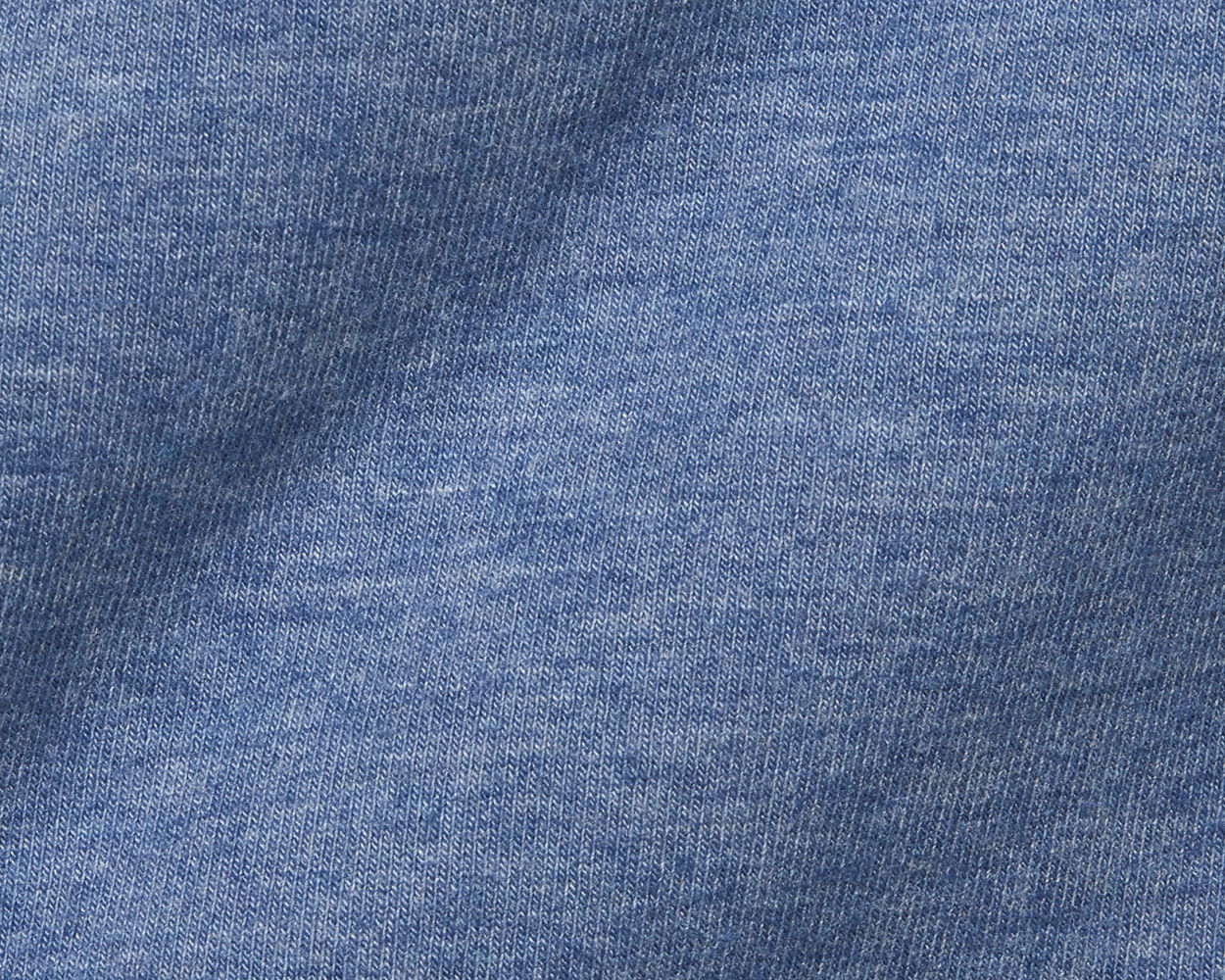 Close-up of The Harper Quarter-Zip: Heathered Bedford showcasing its blue knit fabric with visible looped V stitches, highlighting its soft texture and quality craftsmanship.