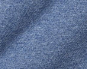 Close-up of The Harper Quarter-Zip: Heathered Bedford showcasing its blue knit fabric with visible looped V stitches, highlighting its soft texture and quality craftsmanship.