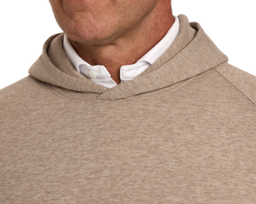Close-up of a person wearing The Lawson Hoodie: Heathered Dune over a white shirt, showcasing its soft fabric and collar detail without drawstrings.
