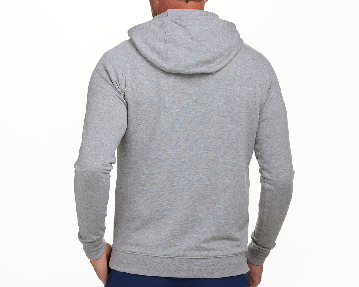 The Lawson Hoodie: Heathered Gray, featuring a hood, fitted waistband, and cuffs, seen from the back on a person wearing dark pants.