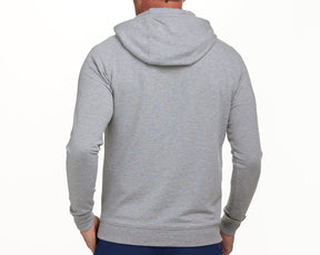 The Lawson Hoodie: Heathered Gray, featuring a hood, fitted waistband, and cuffs, seen from the back on a person wearing dark pants.