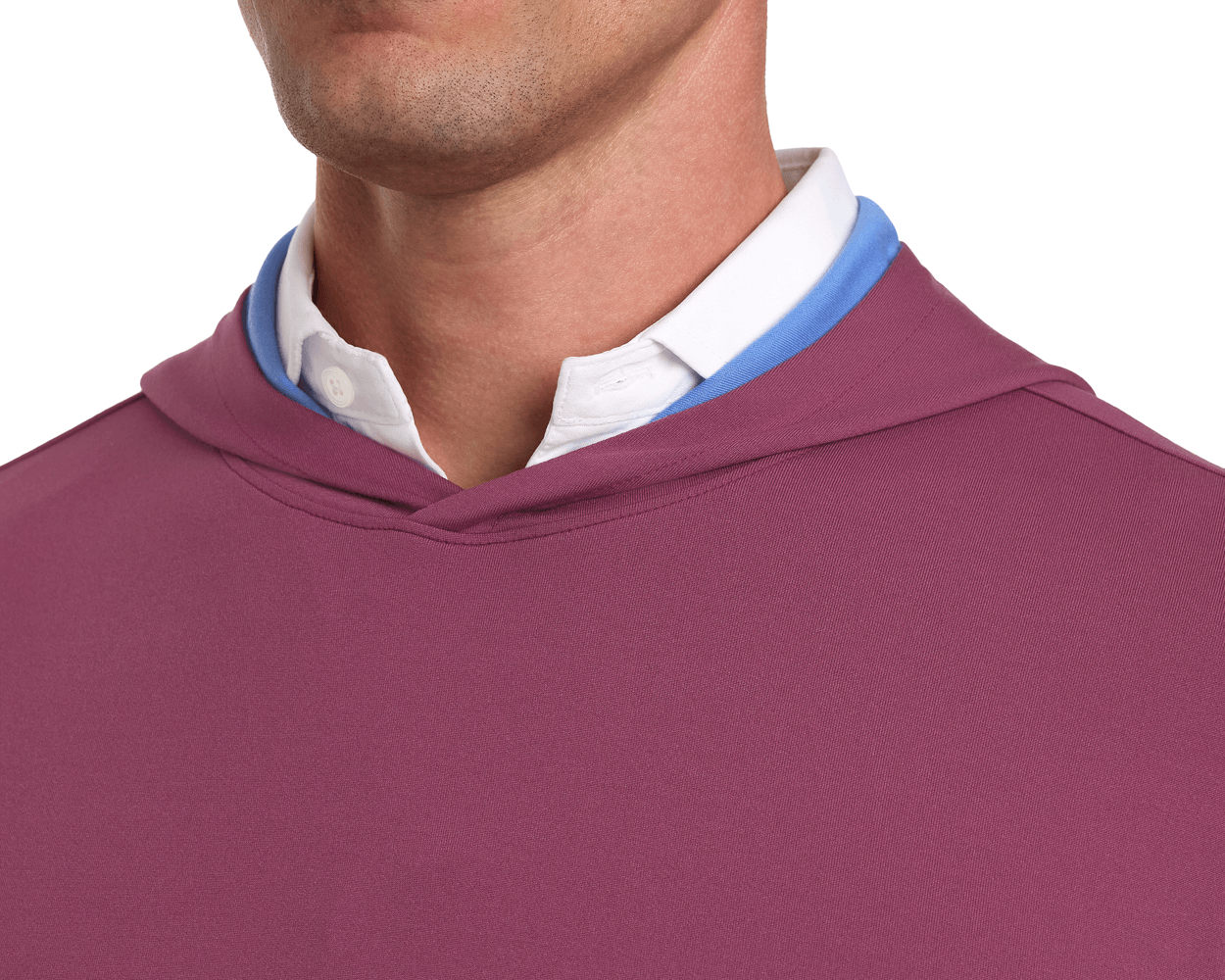 The Jackson Hoodie: Cabernet, layered over a white shirt and light blue garment, showcases a sleek design suitable for golf, emphasizing comfort and minimalism.