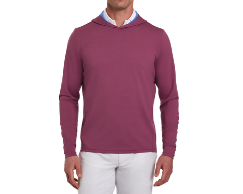 The Jackson Hoodie: Cabernet, shown on a male model, is a slim-fit, long-sleeve hoodie over a collared shirt, paired with light pants.