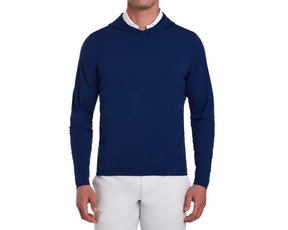 The Jackson Hoodie: Navy, a sleek, long-sleeve pullover layered over a white shirt, paired with light gray trousers, ideal for golf in cooler weather.