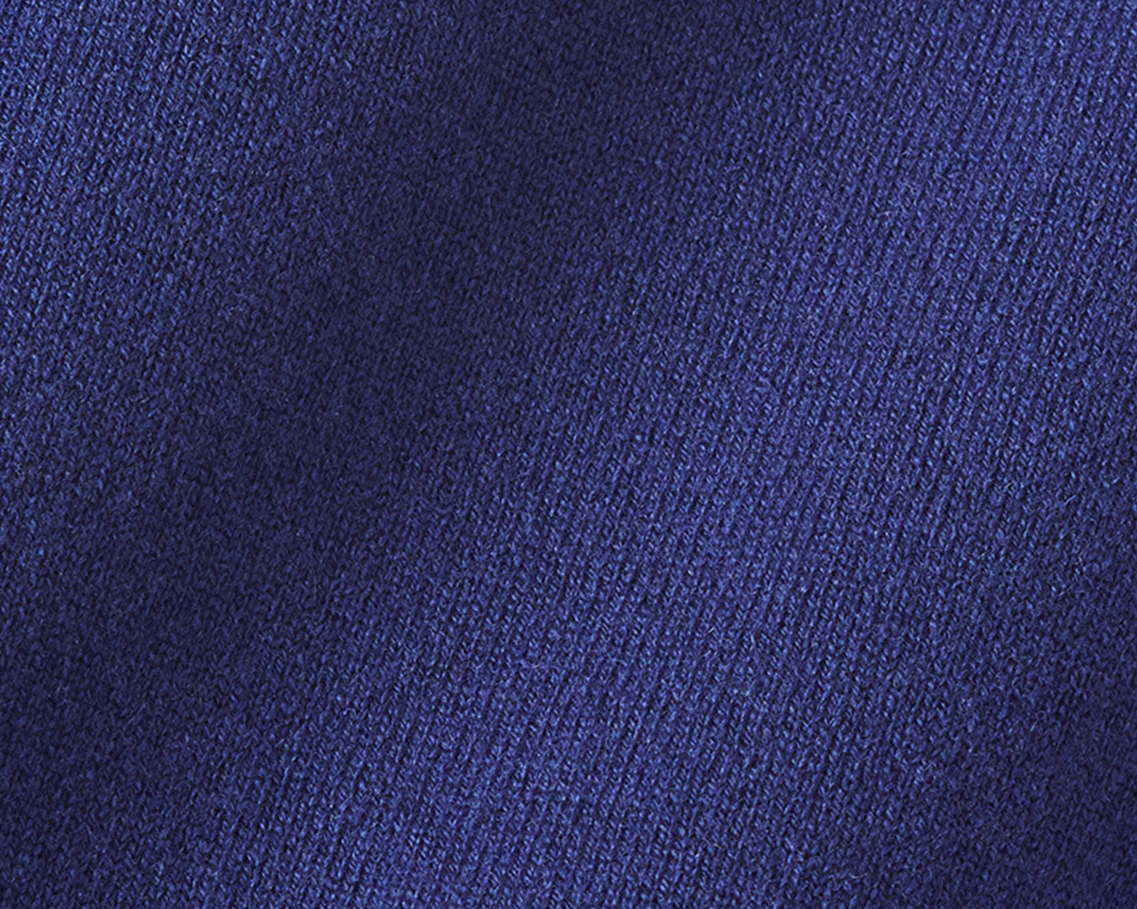 Close-up of The Buckley Crewneck Sweater: Atlantic, showcasing its ribbed knit pattern and luxurious 100% Scottish cashmere fabric with doubled cuff detailing.