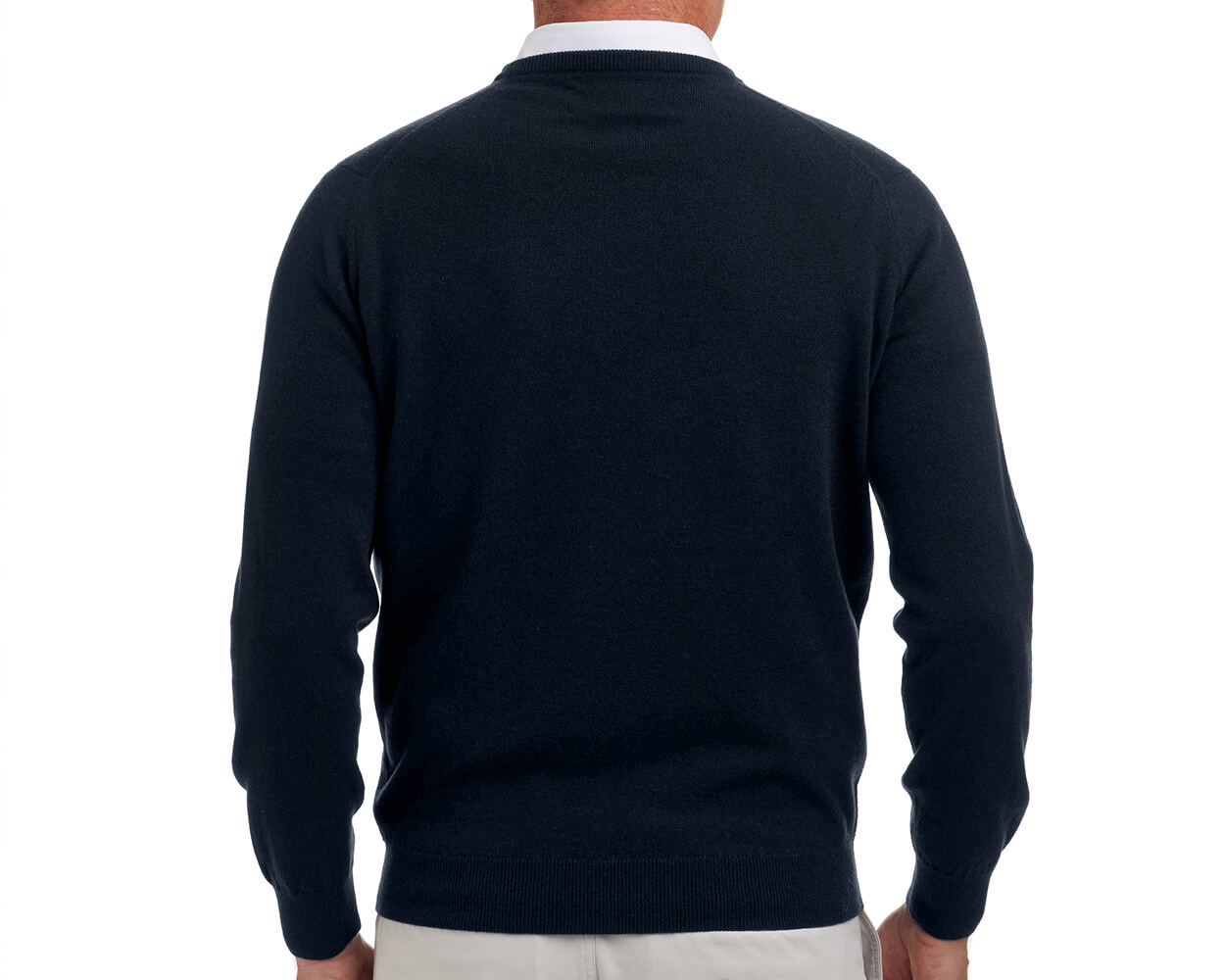 The Buckley Crewneck Sweater: Heathered Dark Navy, shown from the back, layered over a white-collared shirt with beige trousers, highlighting its classic crewneck and durable doubled cuffs.