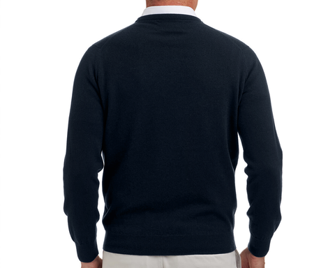 The Buckley Crewneck Sweater: Heathered Dark Navy, shown from the back, layered over a white-collared shirt with beige trousers, highlighting its classic crewneck and durable doubled cuffs.