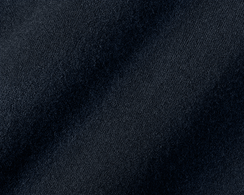 Close-up of The Buckley Crewneck Sweater in Heathered Dark Navy, showcasing 100% Scottish cashmere with a fine diagonal weave pattern and classic crewneck styling.