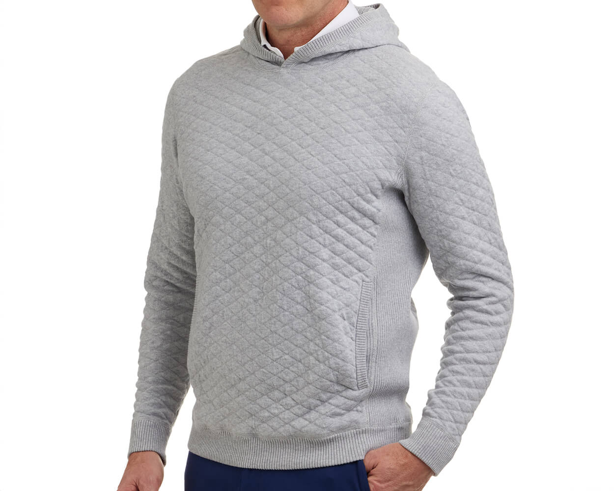 The Wallace Hoodie Sweater: Heathered Gray, features a diamond-quilted design, subtle hood, ribbed cuffs, and a front pouch, worn over a white shirt.