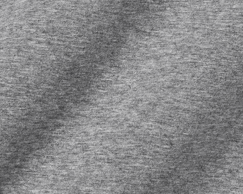 Close-up of The Kennedy Crewneck: Heathered Gray, showcasing its fine jersey knit texture, highlighting the soft, comfortable cotton blend ideal for versatile wear.
