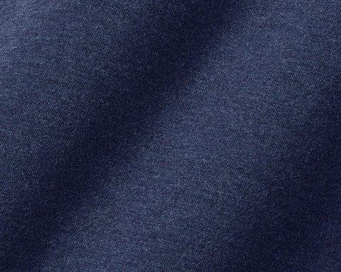 Close-up of The Kennedy Crewneck: Heathered Atlantic, showcasing its fine knit cotton blend fabric with subtle highlights and shadows, emphasizing its soft, plush texture.