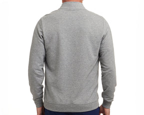 Back view of The Harper Quarter-Zip: Heathered Gray, showcasing its logo below the collar, ribbed cuffs, and hem, worn with dark pants.