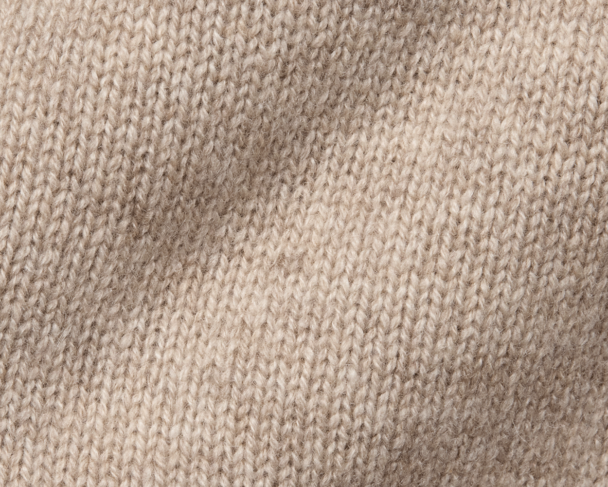 The Berwick Crewneck Sweater: Heathered Dune, close-up of plush, three-ply Scottish cashmere in stockinette stitch, showcasing premium craftsmanship and texture.