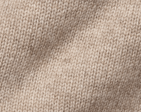 The Berwick Crewneck Sweater: Heathered Dune, close-up of plush, three-ply Scottish cashmere in stockinette stitch, showcasing premium craftsmanship and texture.