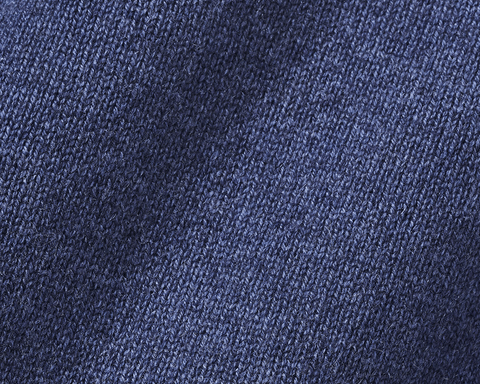 Close-up of The Berwick Crewneck Sweater: Heathered North Sea, showcasing its blue knitted texture with plush, three-ply cashmere and reinforced cuffs.