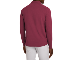 Model wearing The Stuart Quarter-Zip: Cabernet, showing back view with textured rib fabric and luxurious performance blend, paired with light gray bottoms against a white backdrop.