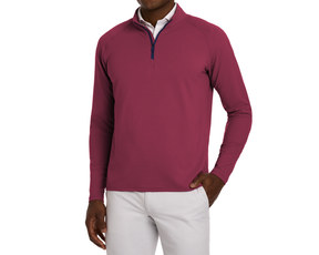 The Stuart Quarter-Zip: Cabernet, showcasing a deep reddish-magenta pullover with a textured rib fabric, over a white shirt, paired with light-gray pants.