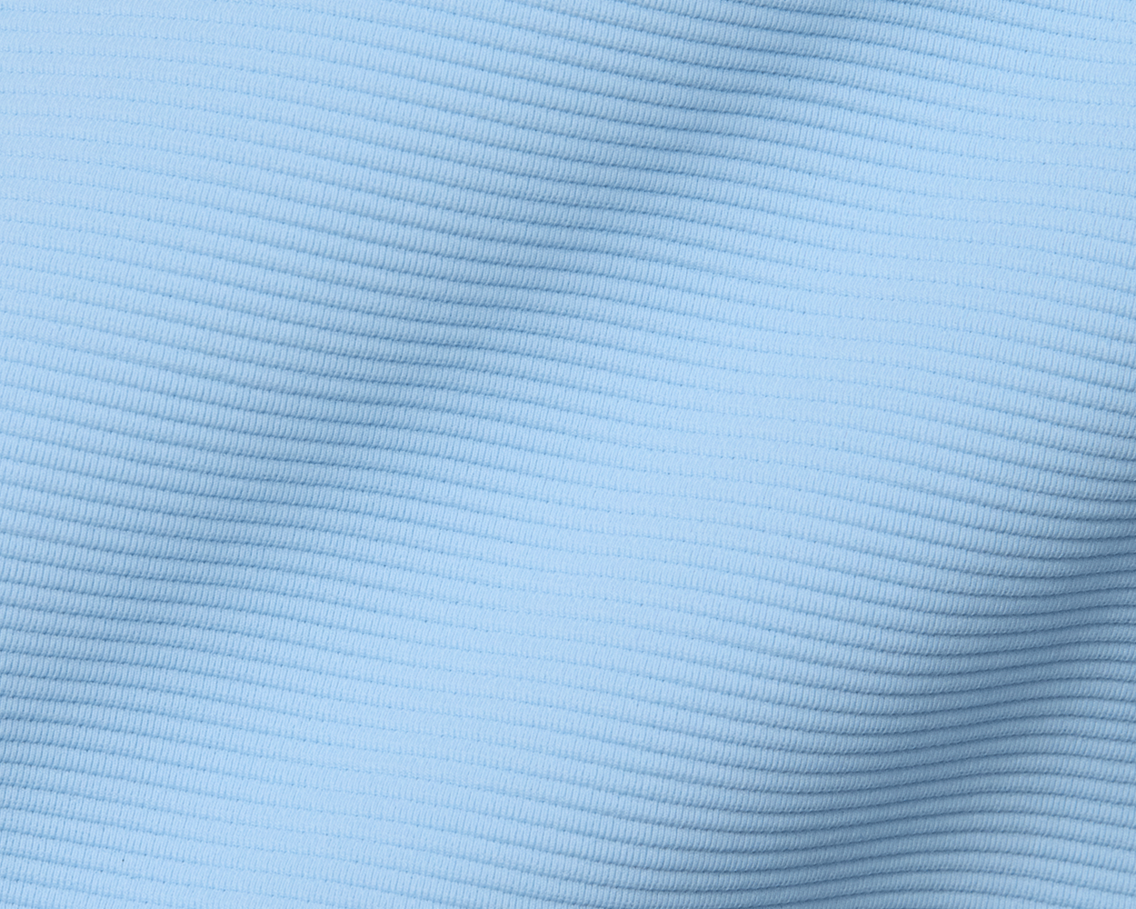 The Stuart Quarter-Zip: Vista Blue features a lightly ribbed, textured fabric with gentle folds, offering a luxurious and versatile look for modern wardrobes.