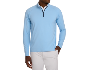 The Stuart Quarter-Zip: Vista Blue worn over a white shirt, featuring a subtle textured rib fabric, paired with light trousers.
