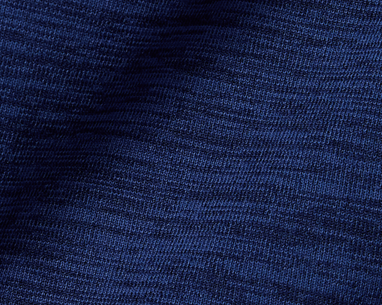 The Laidlay Crewneck: Heathered Navy, showcasing close-up of its soft, wavy knit texture and fine ribbing, highlighting premium stretch and modern sophistication.