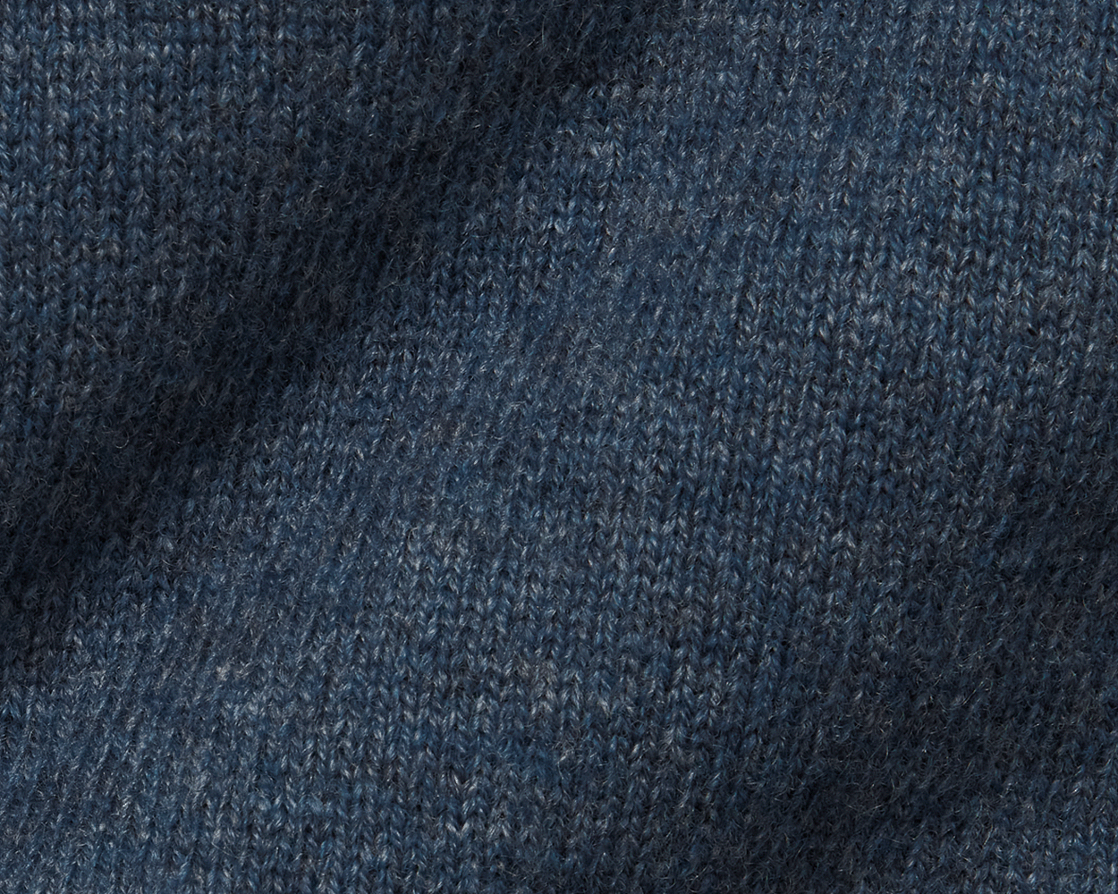 The Logan Hoodie Sweater: Heathered Andover, showcasing close-up of blue knit pattern, highlighting luxurious Merino wool-cashmere blend with ribbed hem, hood, and cuffs.
