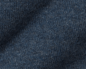 The Logan Hoodie Sweater: Heathered Andover, showcasing close-up of blue knit pattern, highlighting luxurious Merino wool-cashmere blend with ribbed hem, hood, and cuffs.