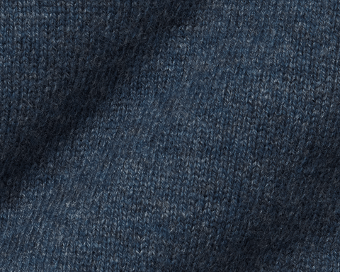 The Logan Hoodie Sweater: Heathered Andover, showcasing close-up of blue knit pattern, highlighting luxurious Merino wool-cashmere blend with ribbed hem, hood, and cuffs.
