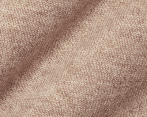 The Logan Hoodie Sweater: Heathered Dune, showcasing soft, beige knitted fabric made from a Merino wool and cashmere blend, featuring ribbed hem, hood, and cuffs.