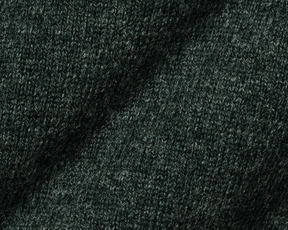 The Logan Hoodie Sweater: Heathered Ivy, showcasing a close-up of its intricate woolen knit texture, highlighting the luxurious Merino and cashmere blend's softness and warmth.