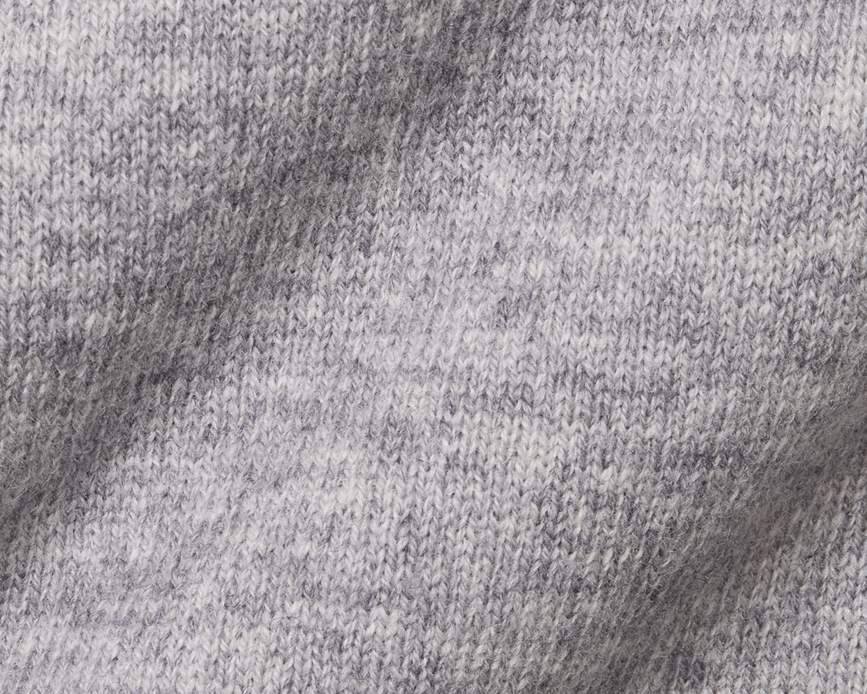 The Logan Hoodie Sweater: Heathered Gray, showcasing a close-up of its marled knit pattern with interlocking loops, highlighting the ribbed hem and cuffs.