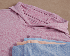 The Hamilton Hoodie: Heathered Cabernet & White features a subtle heathered stripe, lightweight performance blend, and visible Holderness & Bourne label on the folded pink-and-white shirt.
