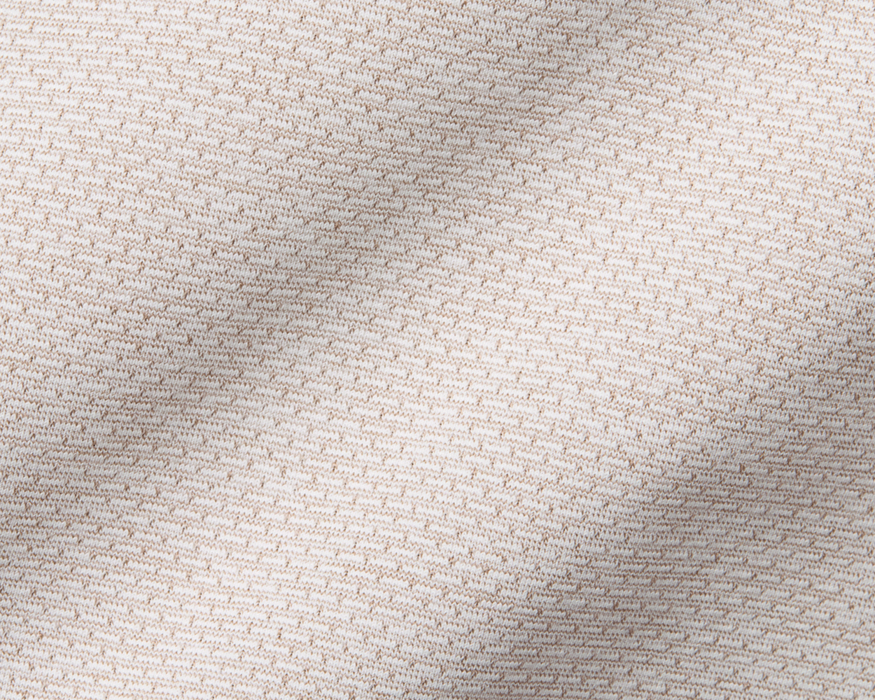 The Bell Quarter-Zip: Heathered Dune, showcasing close-up of soft knit fabric and intricate stitching, highlighting its lightweight, breathable design for versatile, modern styling.