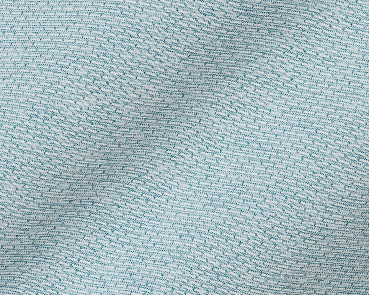 The Bell Quarter-Zip: Heathered Harbor features a close-up of its light teal-blue and off-white knitted fabric, showcasing the textured, breathable jersey-knit fabric.