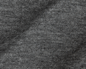 The Sullivan Quarter-Snap: Heathered Charcoal features close-up of soft, heathered knit fabric with visible stitches, highlighting its quilted insulation and classic style.