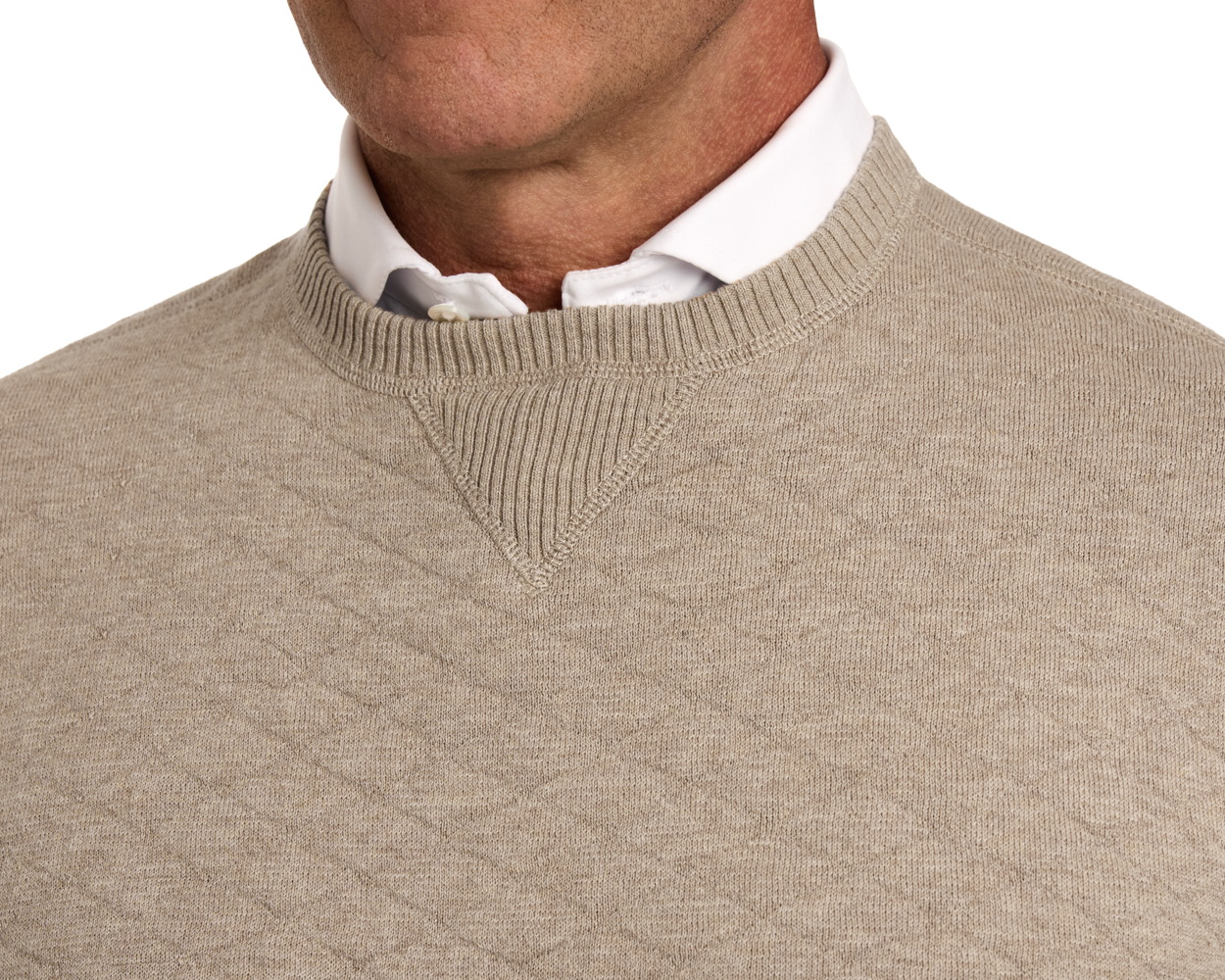 The Ward Crewneck Sweater: Heathered Light Dune features a quilted texture and ribbed detail, layered over a white button-down shirt for a classic look.