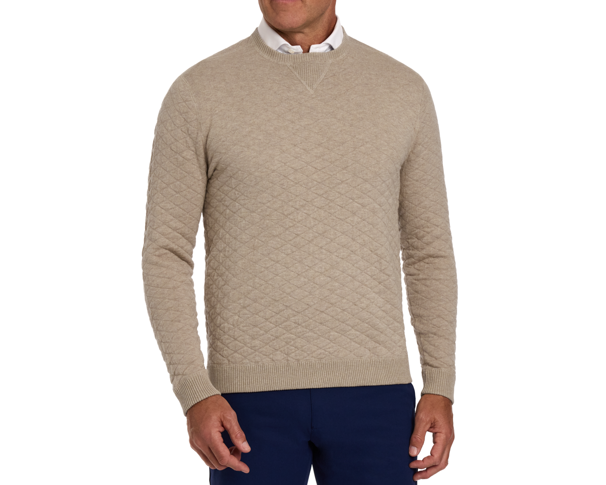 The Ward Crewneck Sweater: Heathered Light Dune features a diamond-quilted design over a white shirt, paired with navy trousers, showcasing its versatile style.