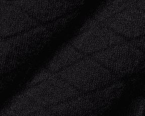 Close-up of The Wallace Hoodie Sweater: Black, showing intricate knit stitches and folded fabric, highlighting its 100% Egyptian cotton texture and ribbed side panels.