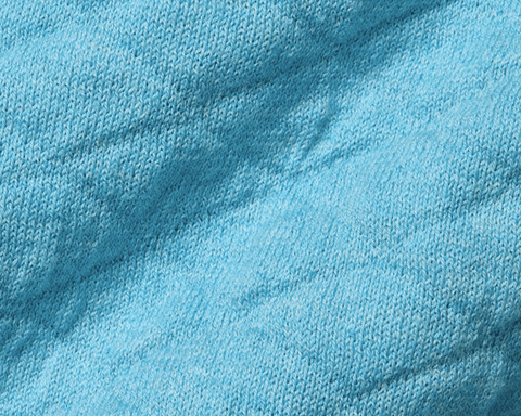 Close-up of The Wallace Hoodie Sweater: Heathered Harbor, showcasing the intricate light-blue knit texture and ribbed side panels in 100% Egyptian cotton.