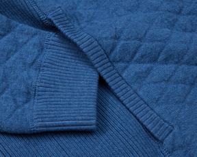 The Wallace Hoodie Sweater features a quilted knit texture with ribbed cuffs, crafted from 100% Egyptian cotton for a modern, warm design.
