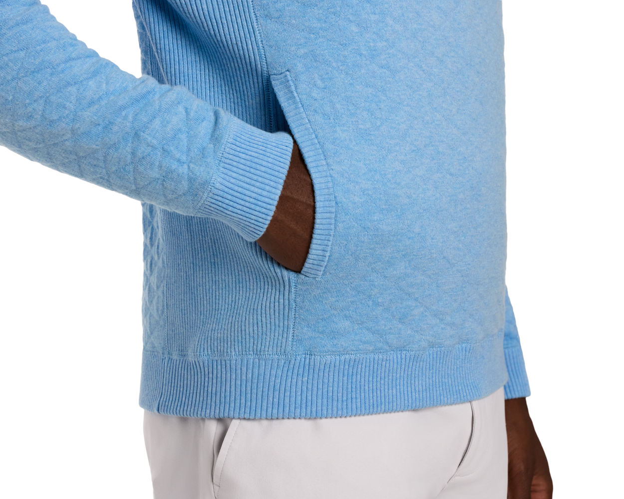 Person wearing The Wallace Hoodie Sweater: Heathered Vista Blue, showcasing ribbed cuffs, hem, side-entry pouch pocket, and streamlined fit with light-colored pants.