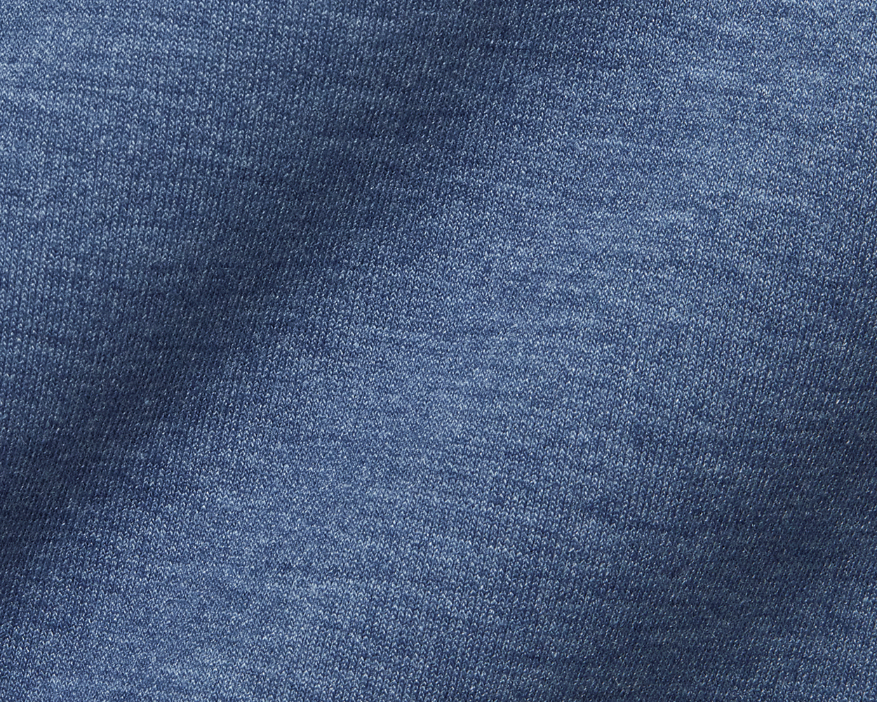 Close-up of the blue knit fabric of The Tilley Quarter-Zip Hoodie: Heathered Andover, highlighting the intricate weave pattern and soft texture for versatile wear.