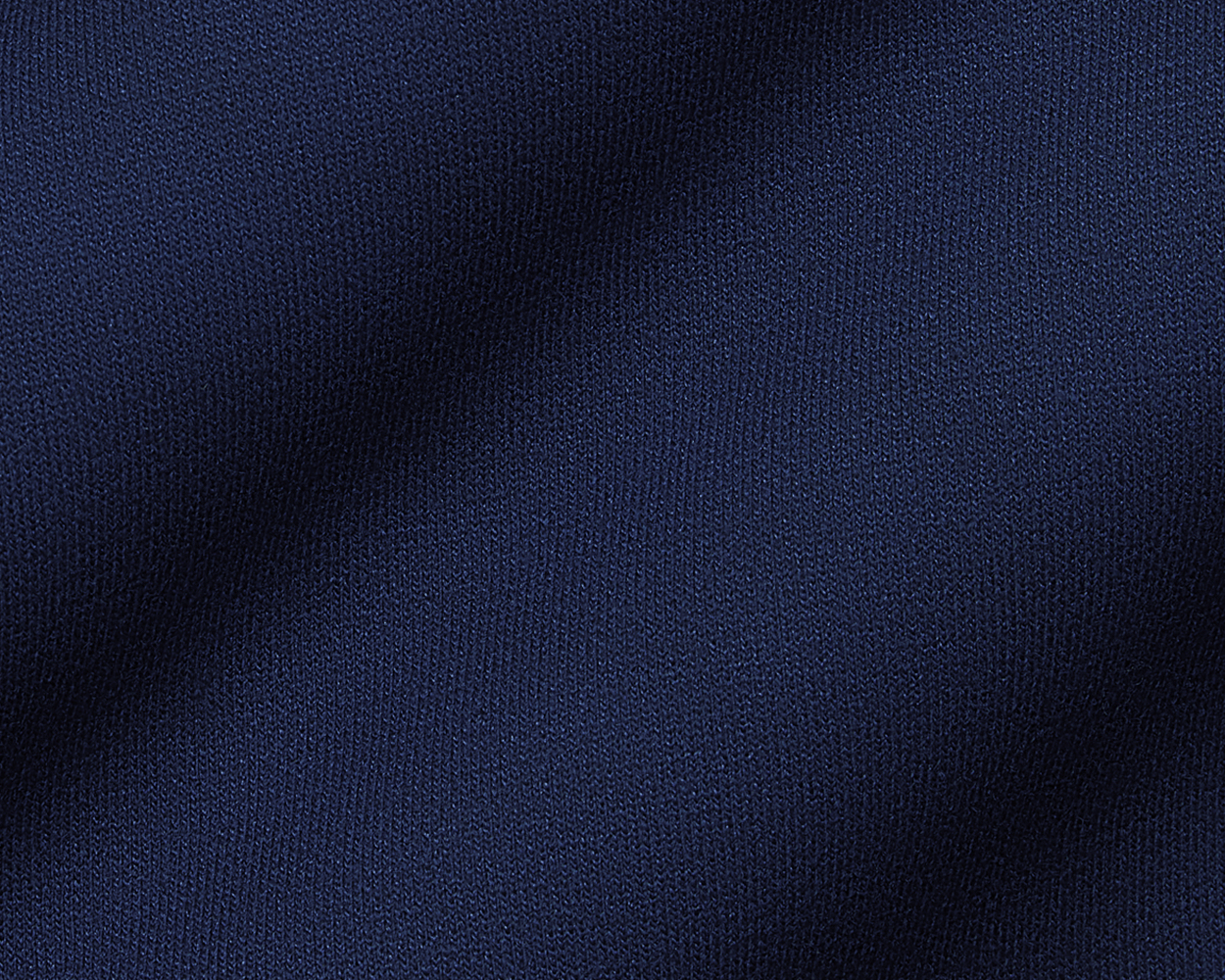 The Tilley Quarter-Zip Hoodie: Heathered Navy showcases a close-up of its intricate knitted texture, highlighting the soft, textured loops ideal for versatile wear.