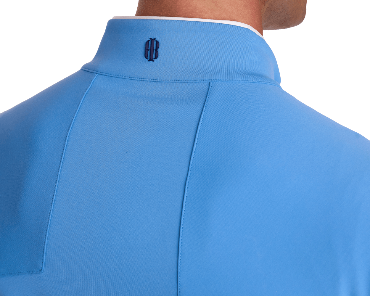 Rear view of The Rodgers Quarter-Zip: Horizon Blue, featuring a light-blue, collared shirt with white trim, back yoke seam, and centered dark embroidered logo.