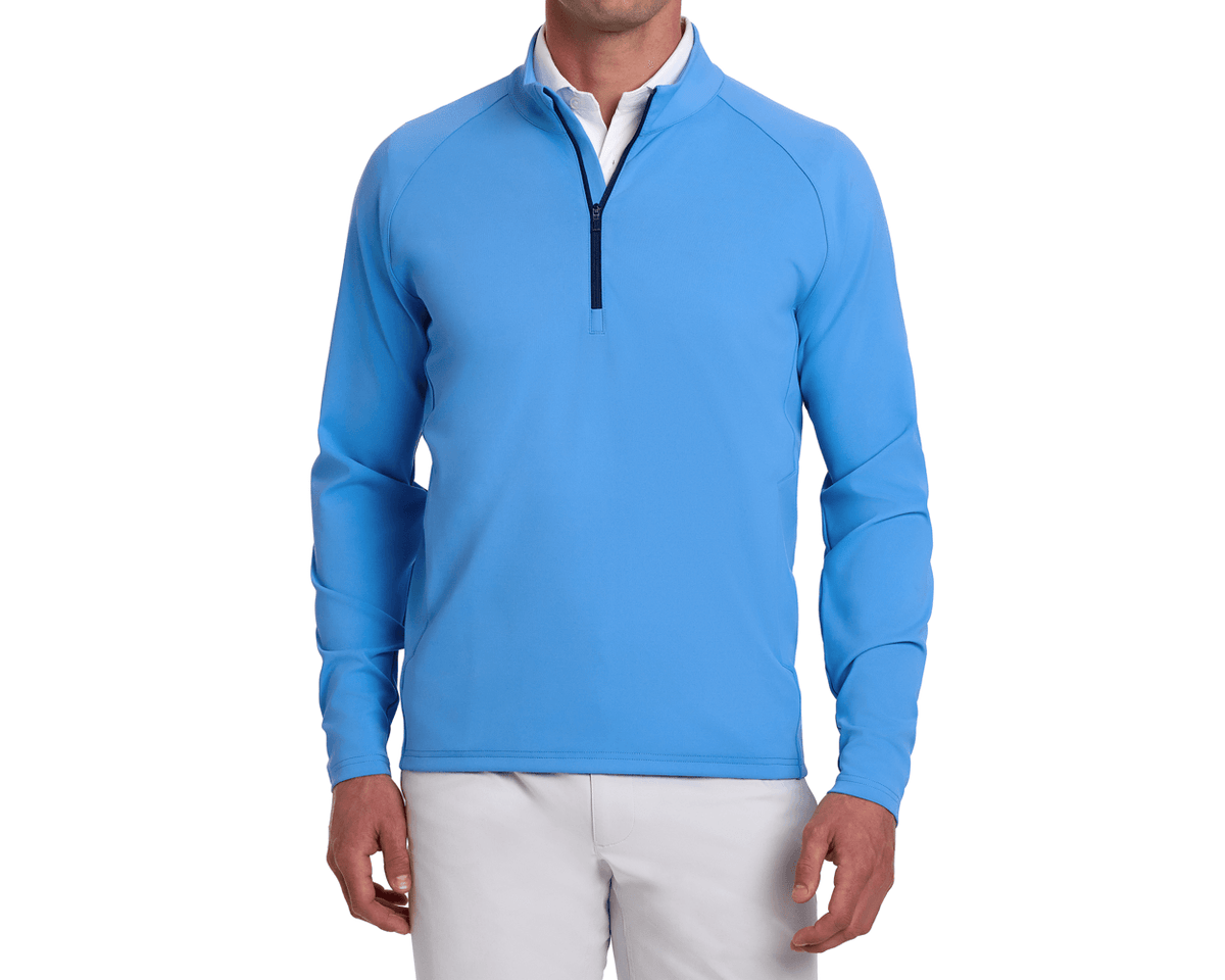 Male model wearing The Rodgers Quarter-Zip: Horizon Blue over a white collared shirt, paired with light-colored pants, showcasing the pullover's fit and style.