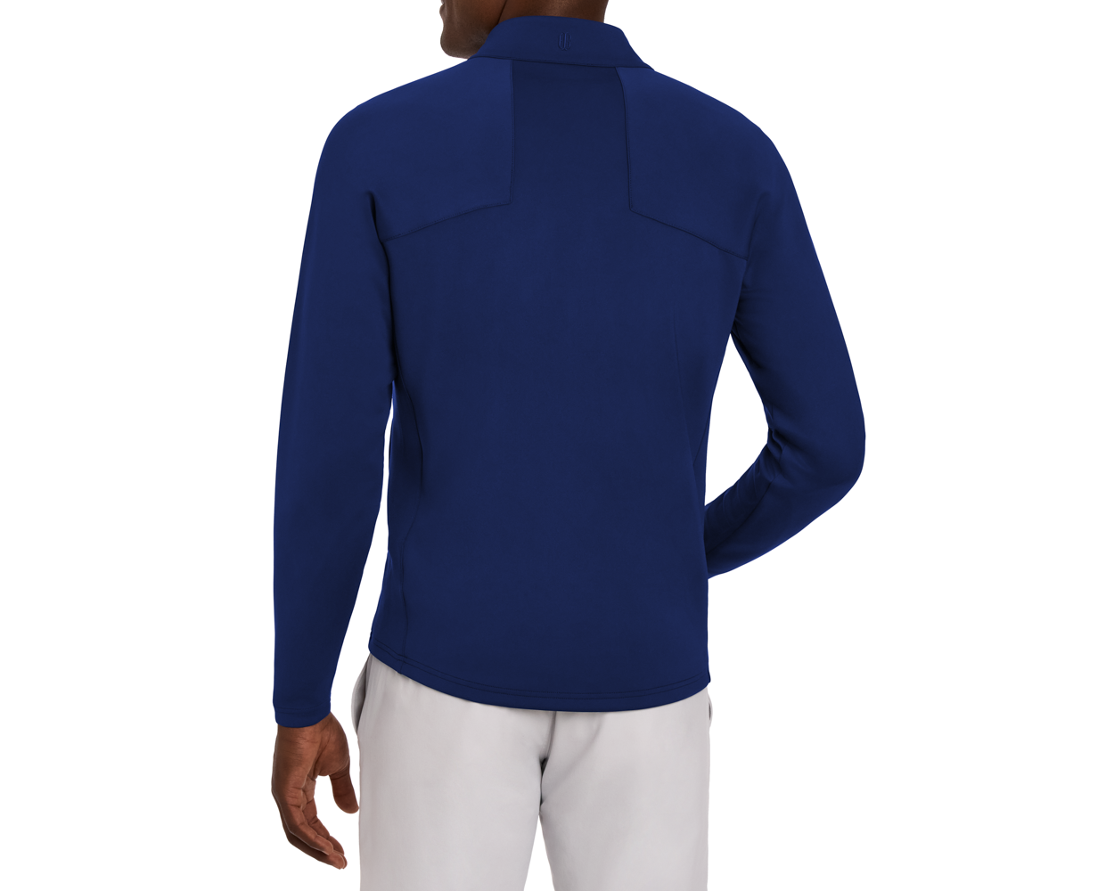 Back view of a man in The Rodgers Quarter-Zip: Navy, featuring a fitted athletic design with a stand-up collar, paired with light-gray pants.