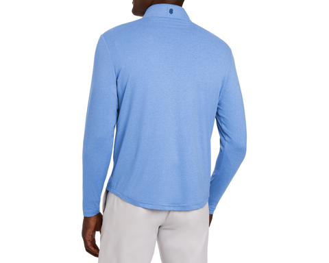 The Royce Quarter-Zip: Heathered Horizon Blue, featuring a textured pullover with a back logo, worn over light-gray trousers, ideal for golf or office settings.